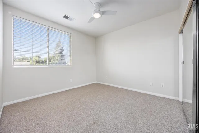 a view of a house with a big yard and large tree