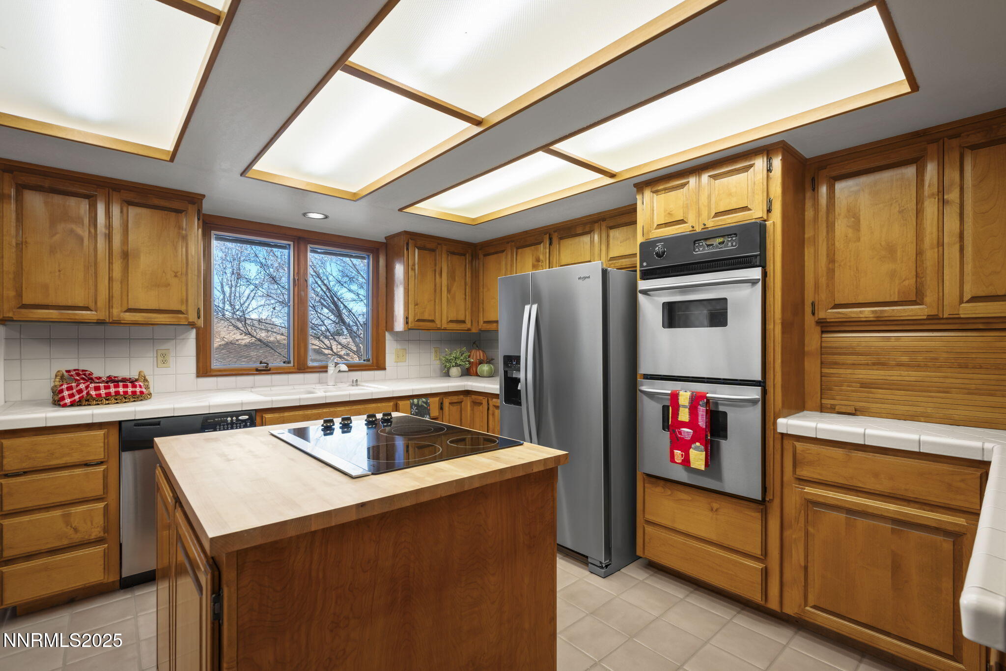 1443 Copper Point Circle Reno, NV 89519 - Photo 11 of 33 a kitchen that has a sink cabinets stainless steel appliances and a window