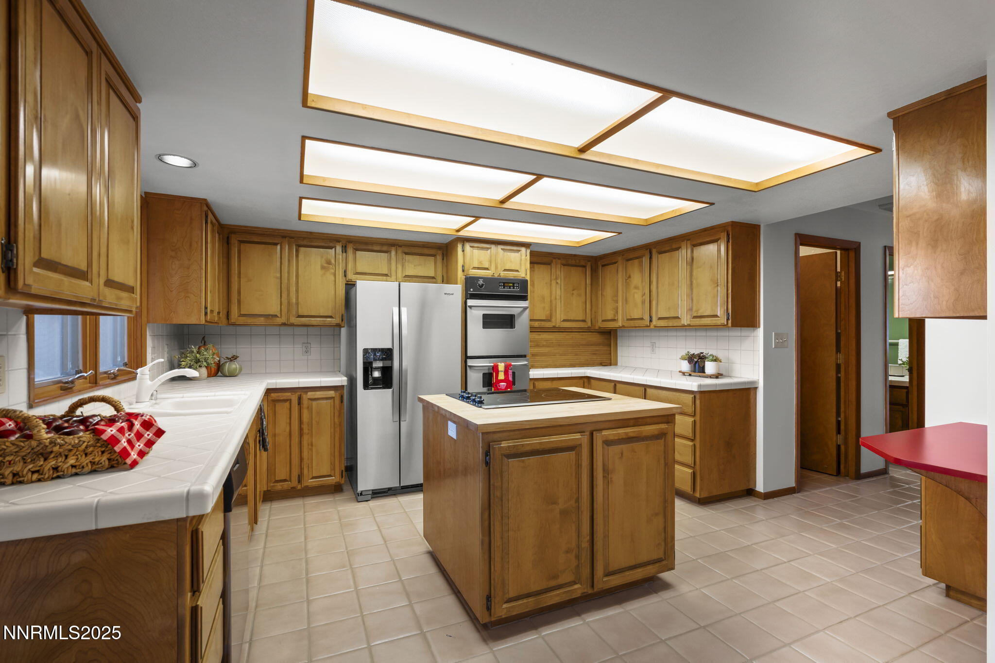 1443 Copper Point Circle Reno, NV 89519 - Photo 12 of 33 a kitchen with a sink a refrigerator and cabinets