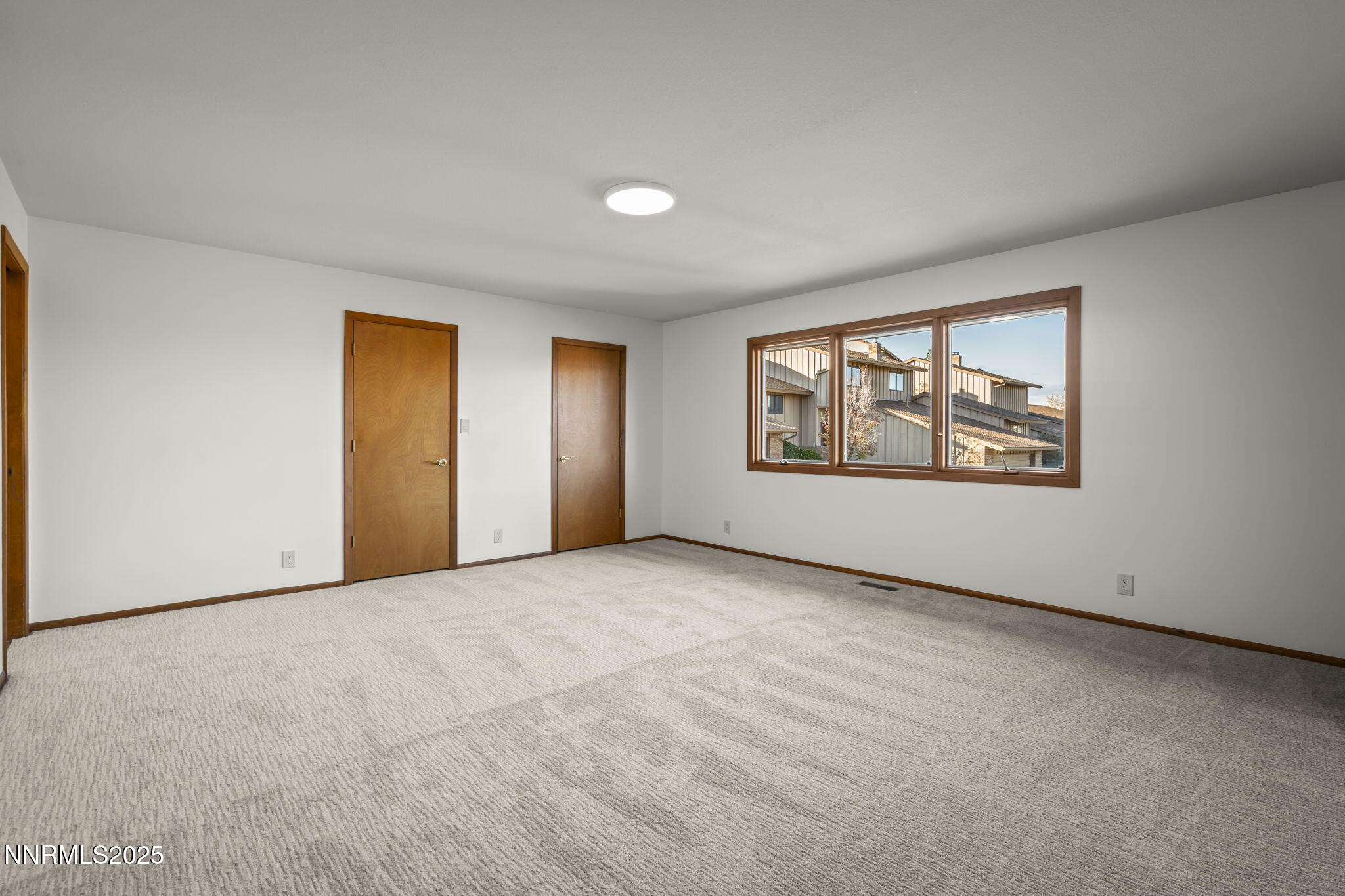 1443 Copper Point Circle Reno, NV 89519 - Photo 15 of 33 an empty room with windows and closet