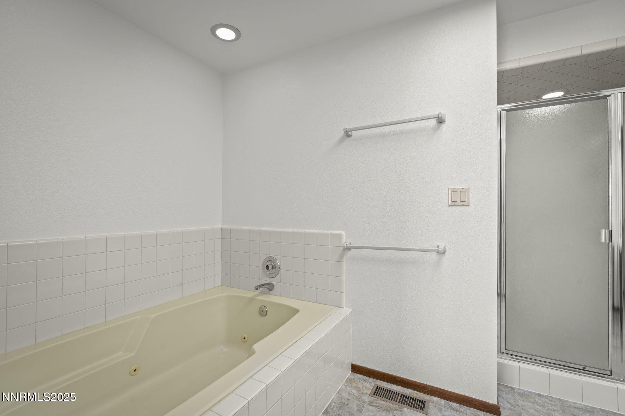 1443 Copper Point Circle Reno, NV 89519 - Photo 17 of 33 a bathroom with a tub and a shower