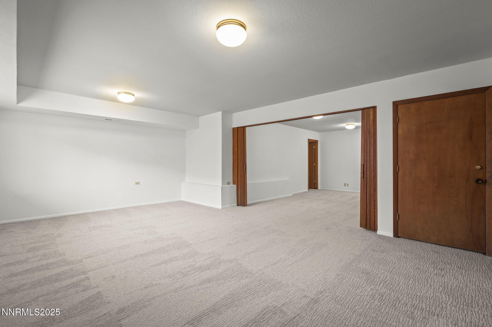 1443 Copper Point Circle Reno, NV 89519 - Photo 25 of 33 an empty room with closet and mirror