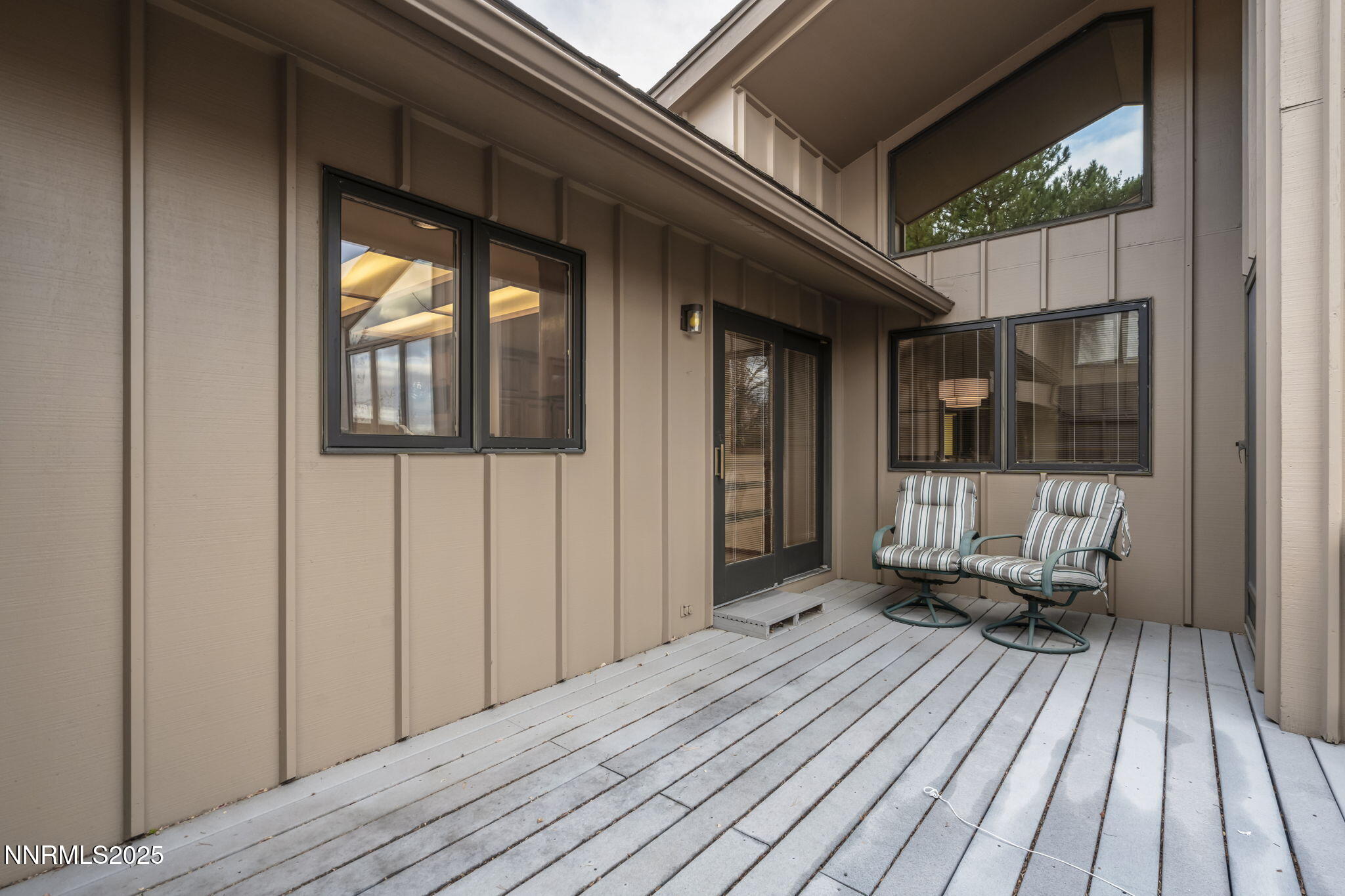 1443 Copper Point Circle Reno, NV 89519 - Photo 32 of 33 a view of a brick house with a wooden deck