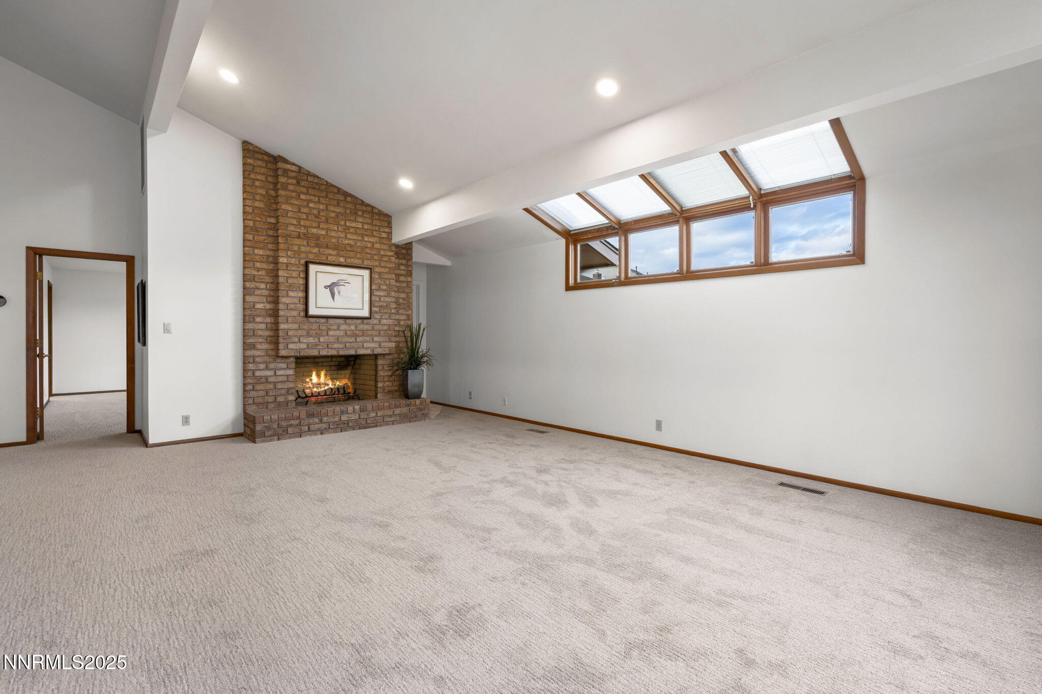 1443 Copper Point Circle Reno, NV 89519 - Photo 5 of 33 an empty room with windows and fireplace