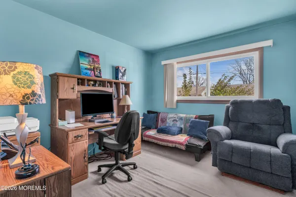 a livingroom with workspace and a couch