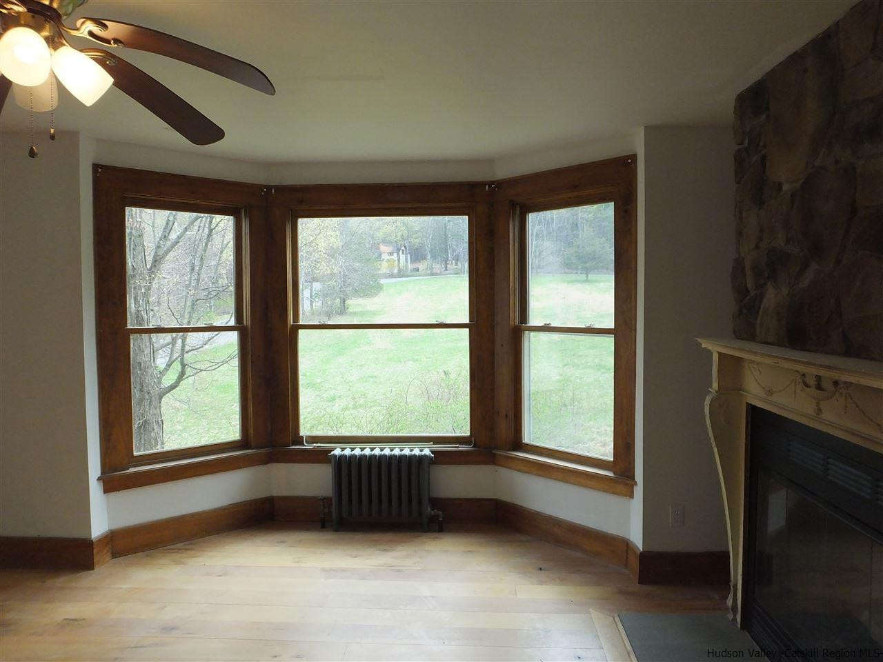 300 Vly Atwood Road Stone Ridge, NY 12484 - Photo 11 of 31 a view of an empty room with a fireplace and a window