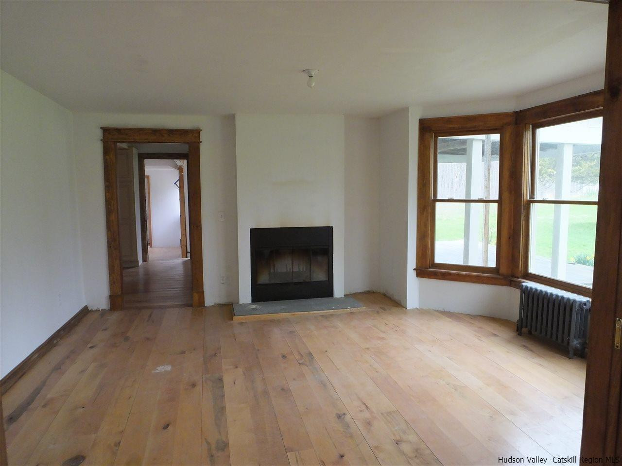 300 Vly Atwood Road Stone Ridge, NY 12484 - Photo 13 of 31 a view of an empty room with a window and a fireplace