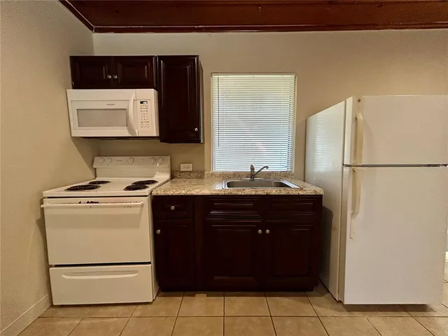 a kitchen with a refrigerator and a sink