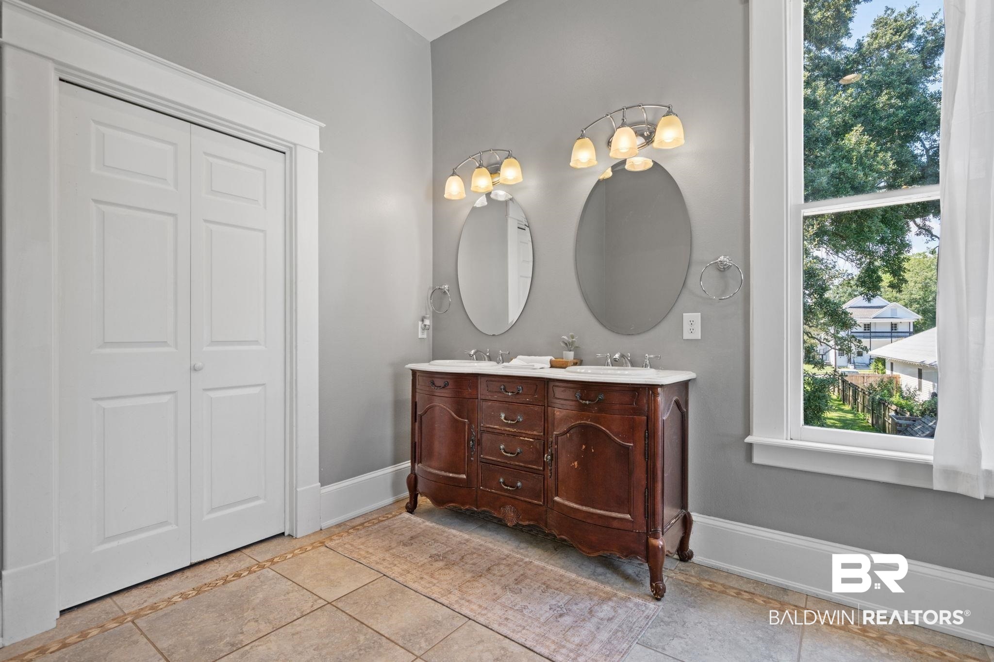 10 South Monterey Street Mobile, AL 36604 - Photo 26 of 45 Bathroom with double vanity, light tile patterned floors, and a closet