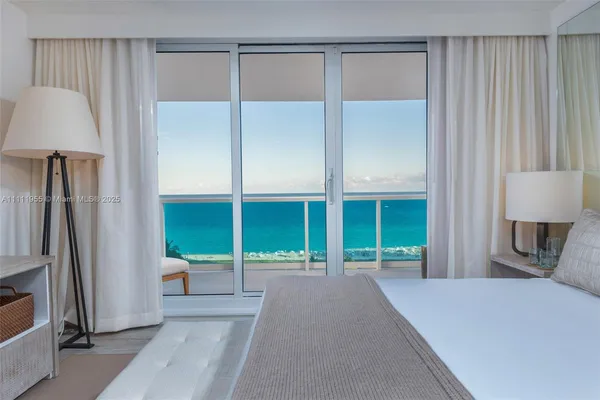 a bedroom with a bed and a large window