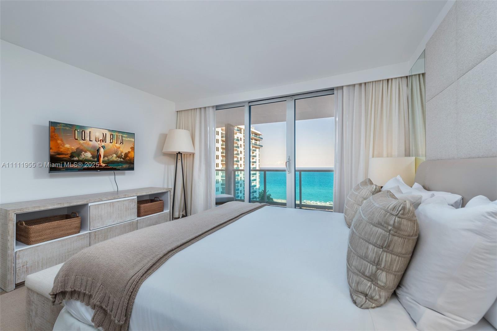 102 24th Street, Unit 1144 Miami Beach, FL 33139 - Photo 14 of 21 a bedroom with a bed and a flat screen tv