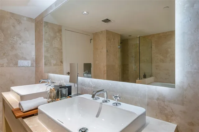 a bathroom with double vanity sink and a mirror