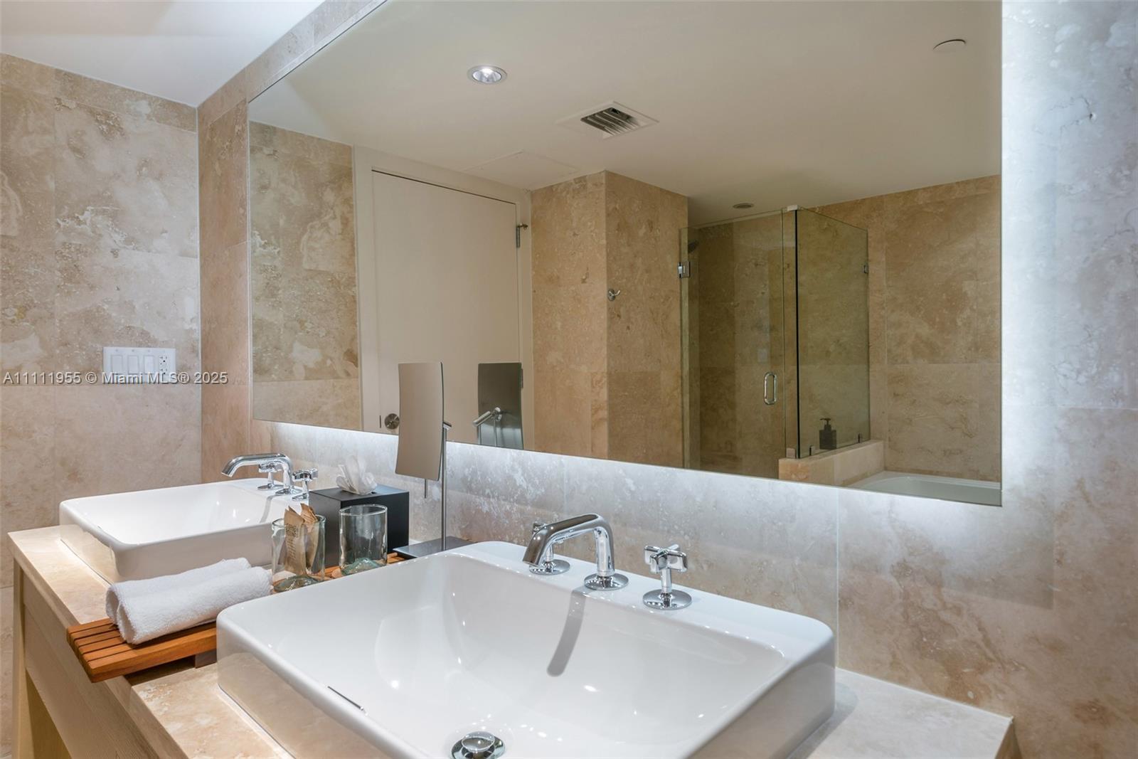 102 24th Street, Unit 1144 Miami Beach, FL 33139 - Photo 16 of 21 a bathroom with double vanity sink and a mirror