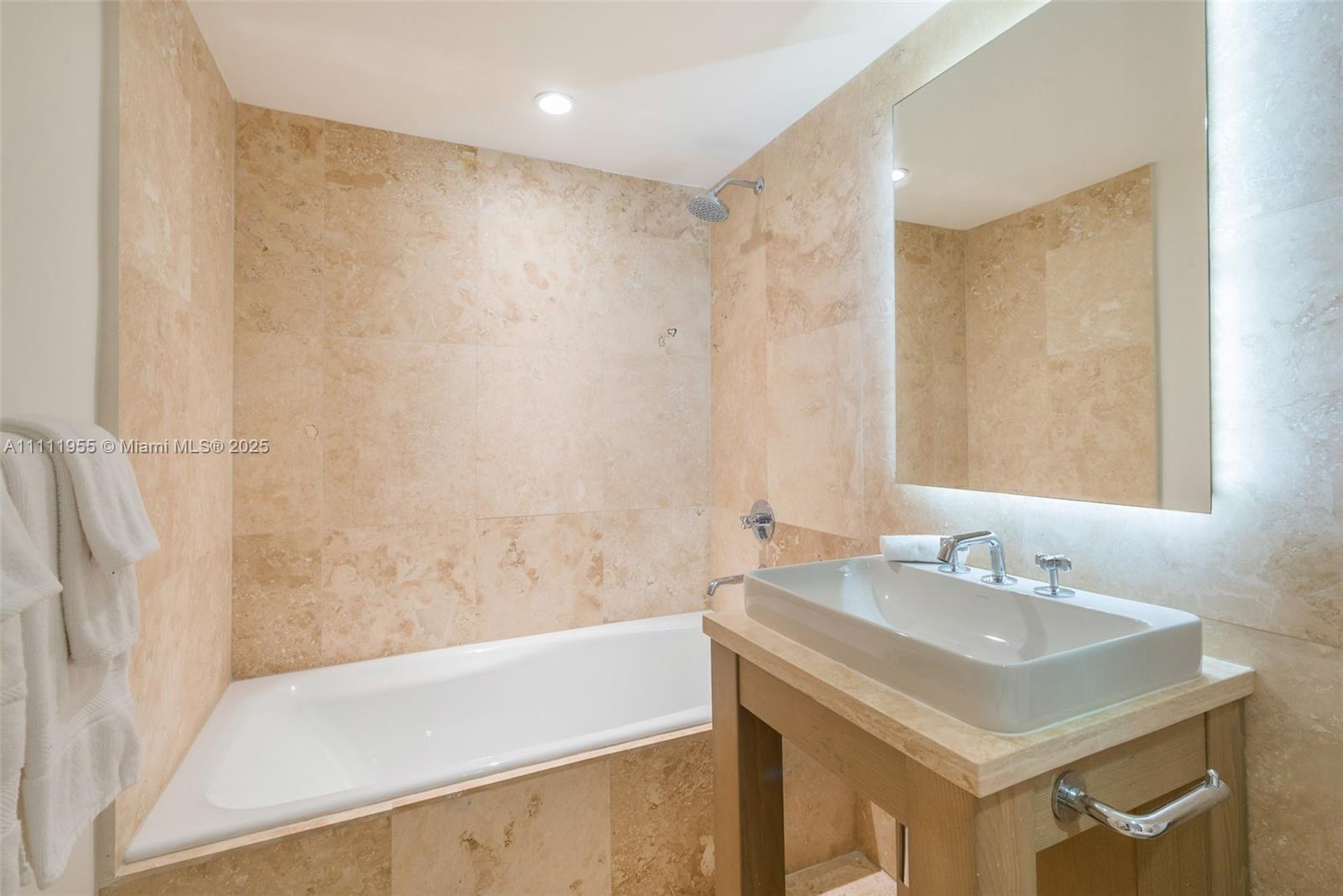 102 24th Street, Unit 1144 Miami Beach, FL 33139 - Photo 17 of 21 a bathroom with a sink and a mirror