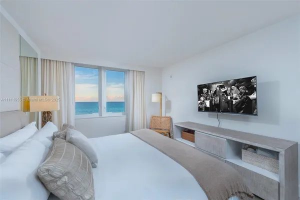 a bedroom with a large bed and a couch