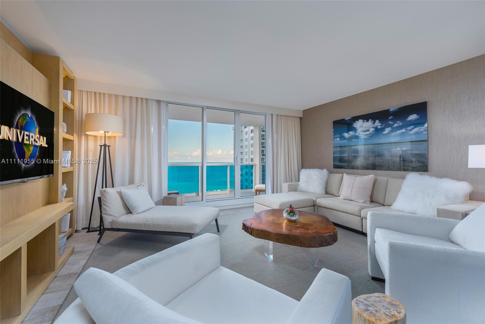 102 24th Street, Unit 1144 Miami Beach, FL 33139 - Photo 8 of 21 a living room with furniture and a flat screen tv