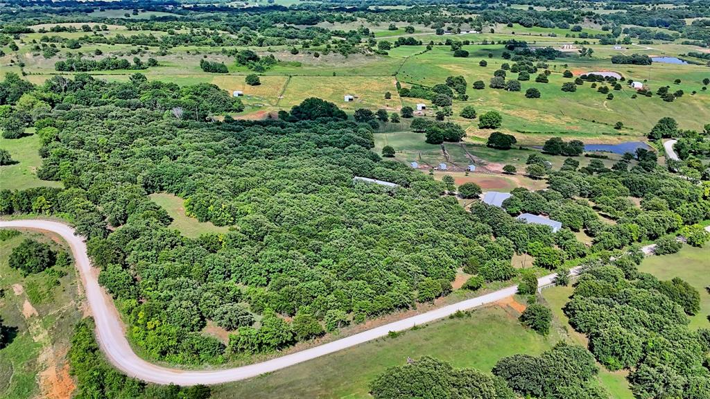 4509 Lazy E Road St. Jo, TX 76265 - Photo 34 of 39 an aerial view of residential houses with outdoor space and trees