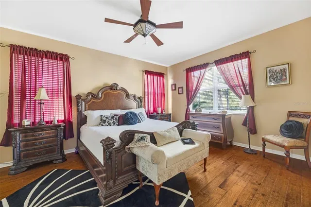 a living room with furniture a flat screen tv and a large window