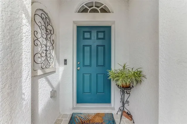 a living room with furniture and a view of kitchen