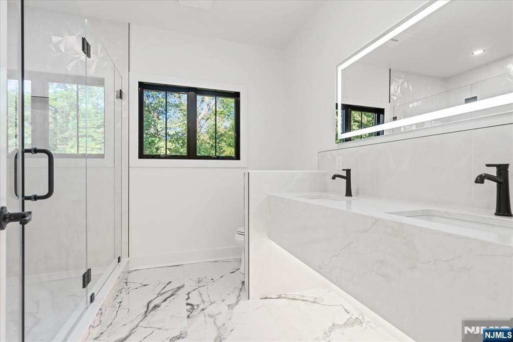 23 Brook Road Upper Saddle River, NJ 07458 - Photo 23 of 27 a bathroom with a bathtub and a shower