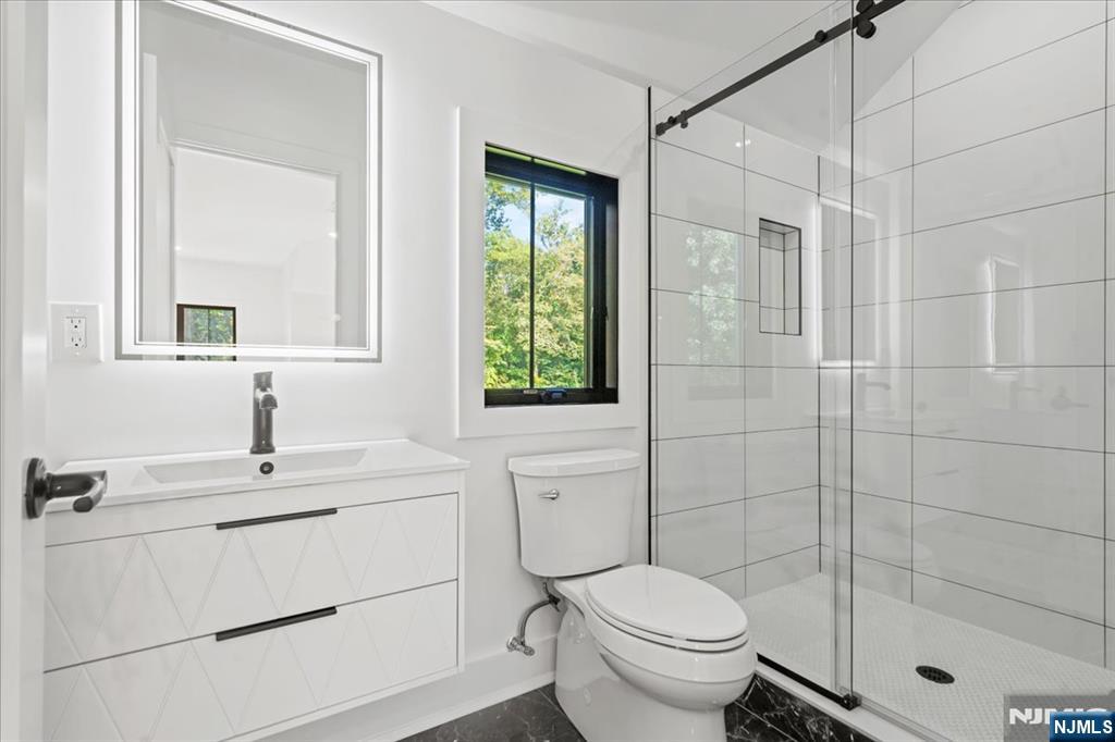 23 Brook Road Upper Saddle River, NJ 07458 - Photo 24 of 27 a bathroom with a sink toilet and shower