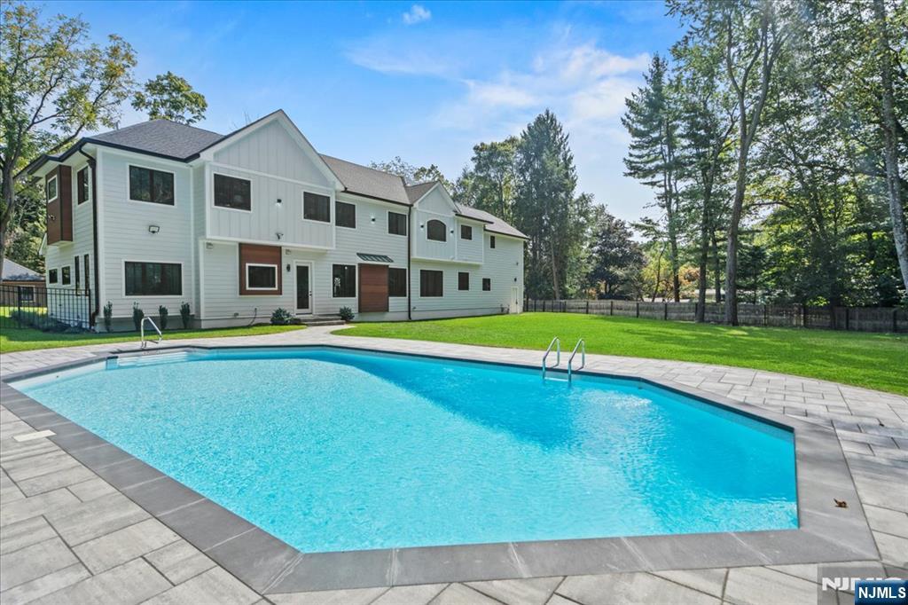 23 Brook Road Upper Saddle River, NJ 07458 - Photo 5 of 27 a view of pool with large trees and a big yard with swimming pool in the back