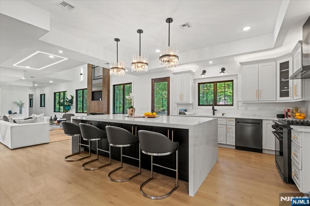 23 Brook Road Upper Saddle River, NJ 07458 - Photo 7 of 27 a kitchen with kitchen island granite countertop a sink table and chairs