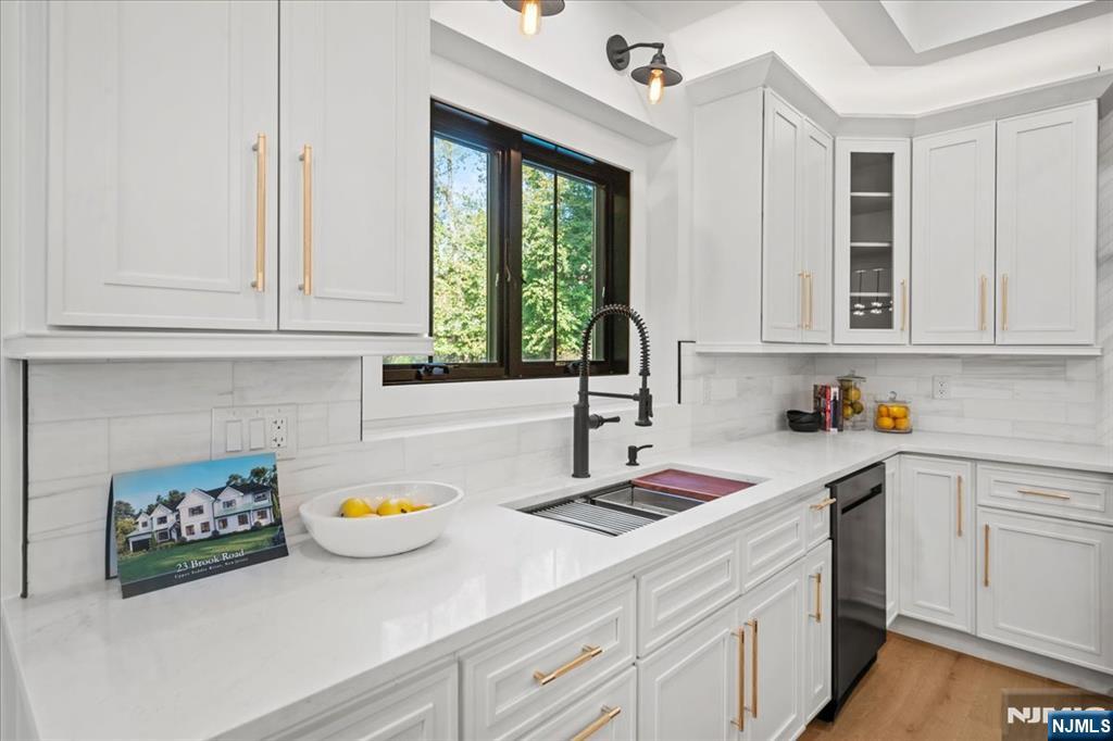23 Brook Road Upper Saddle River, NJ 07458 - Photo 8 of 27 a kitchen with stainless steel appliances granite countertop a sink a stove and cabinets