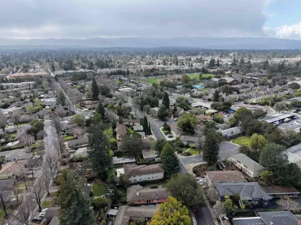 an aerial view of multiple houses with yard