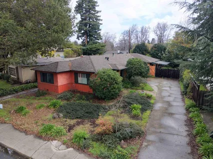 an aerial view of house with yard and mountain view in back