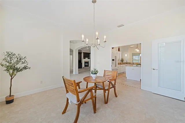 a kitchen with kitchen island granite countertop a stove a sink a oven and a kitchen island