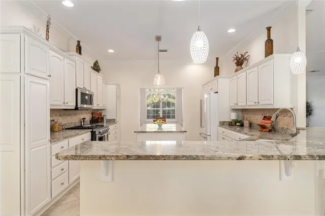 a view of a kitchen with a sink and cabinets