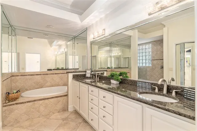 an aerial view of ocean and residential houses with outdoor space