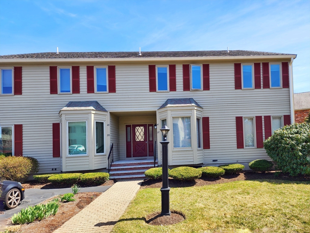 a front view of a house with swimming pool and porch