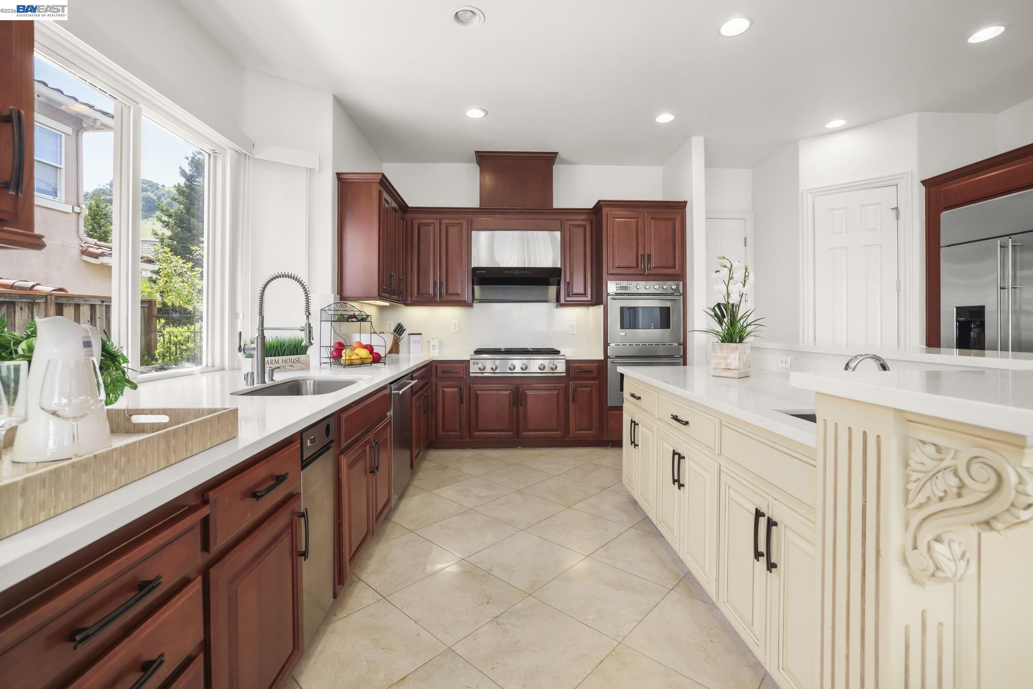 950 Winsford Court San Ramon, CA 94583 - Photo 24 of 68 a large kitchen with stainless steel appliances kitchen island granite countertop a sink and cabinets