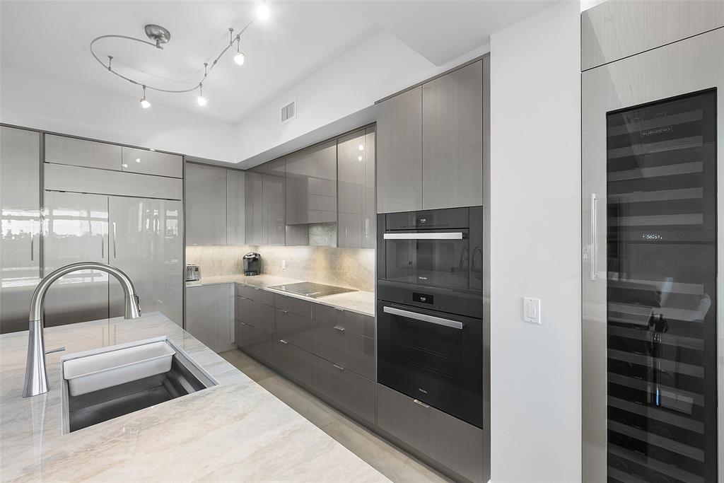 701 Southeast 21st Avenue, Unit 301 Deerfield Beach, FL 33441 - Photo 11 of 63 a kitchen with granite countertop a refrigerator and a sink