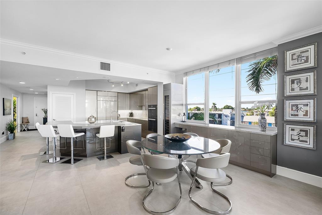701 Southeast 21st Avenue, Unit 301 Deerfield Beach, FL 33441 - Photo 14 of 63 a dining room with furniture a rug and white walls