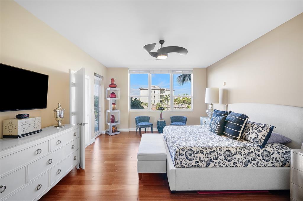 701 Southeast 21st Avenue, Unit 301 Deerfield Beach, FL 33441 - Photo 23 of 63 a bedroom with furniture and flat screen tv