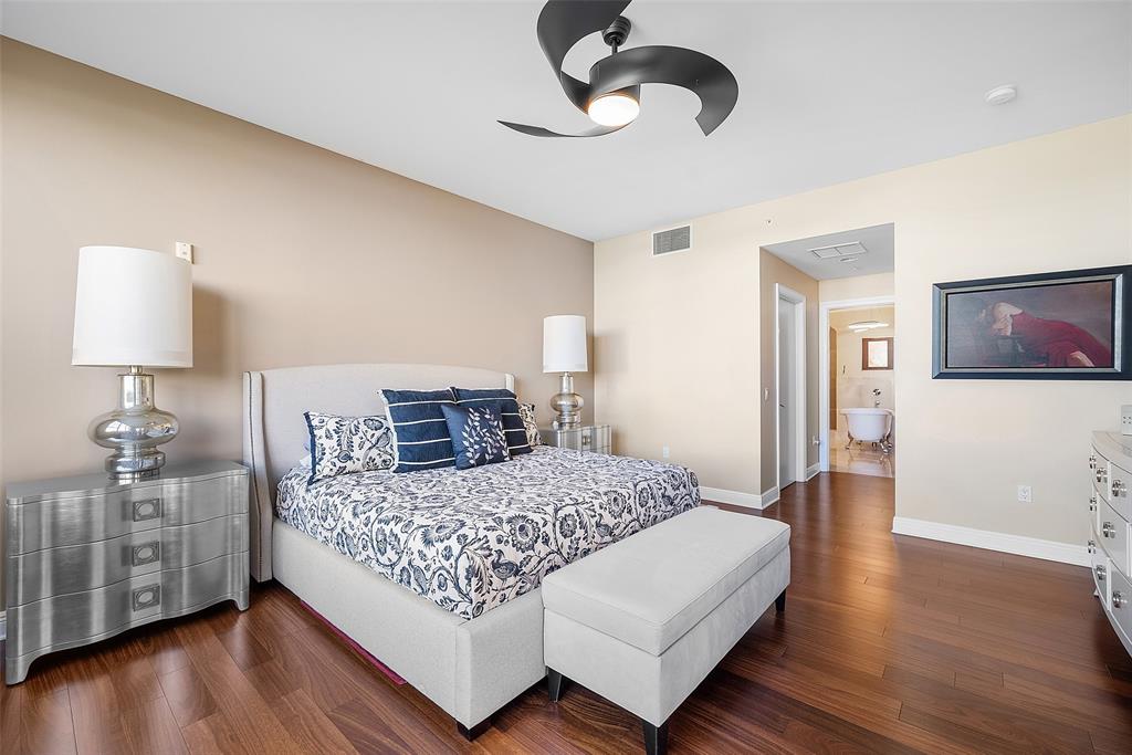 701 Southeast 21st Avenue, Unit 301 Deerfield Beach, FL 33441 - Photo 25 of 63 a bedroom with a bed and wooden floor