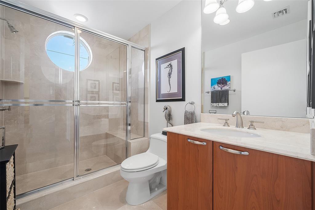 701 Southeast 21st Avenue, Unit 301 Deerfield Beach, FL 33441 - Photo 30 of 63 a bathroom with a sink a toilet and shower