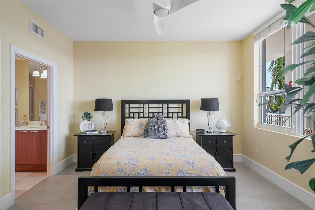 701 Southeast 21st Avenue, Unit 301 Deerfield Beach, FL 33441 - Photo 31 of 63 a large bedroom with a bed and wooden floor