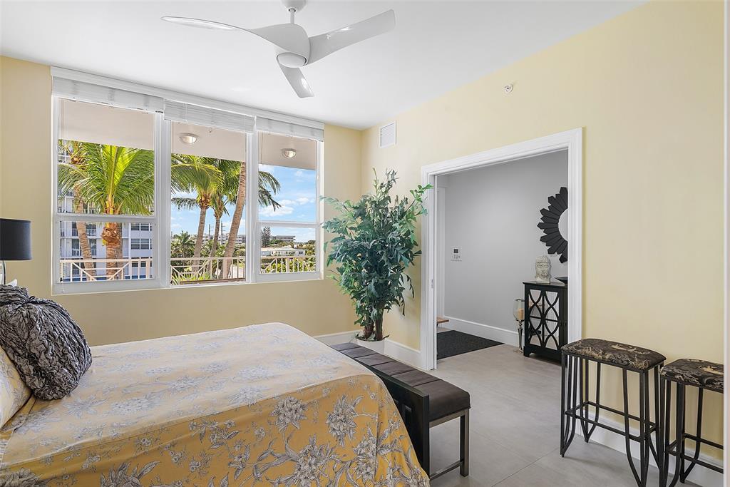 701 Southeast 21st Avenue, Unit 301 Deerfield Beach, FL 33441 - Photo 32 of 63 a bedroom with a bed and a large window with the outer view