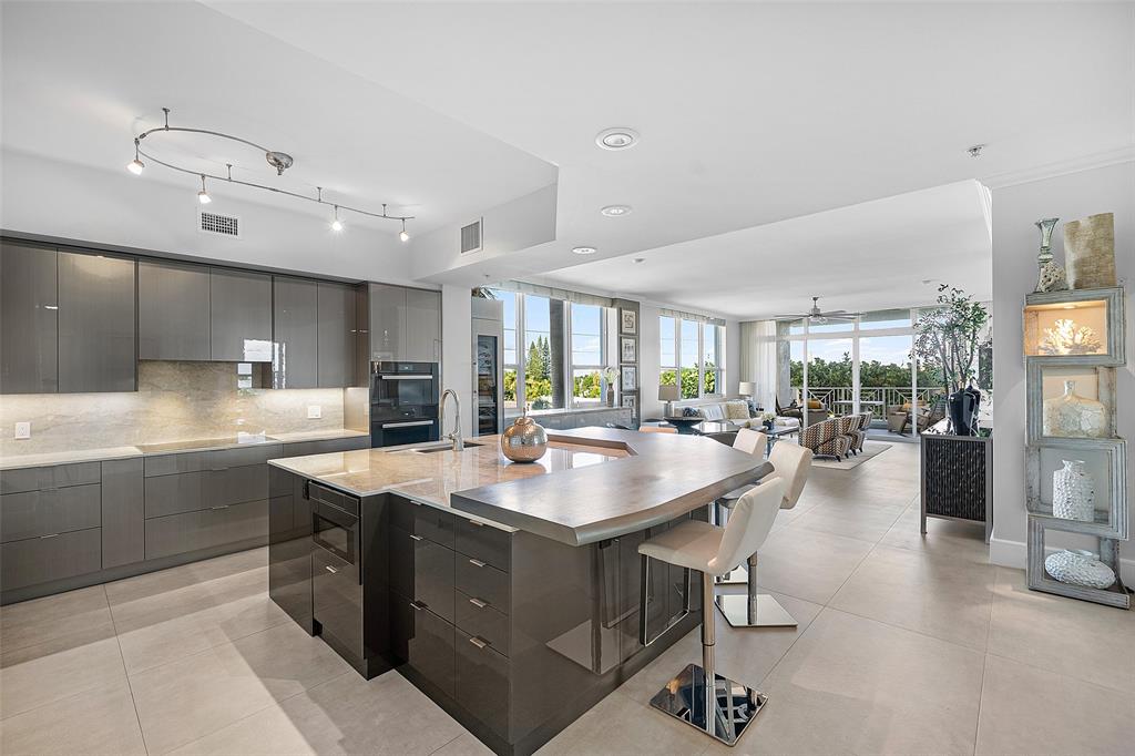 701 Southeast 21st Avenue, Unit 301 Deerfield Beach, FL 33441 - Photo 8 of 63 a dining hall with stainless steel appliances granite countertop a sink and a stove