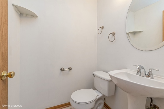 16136 Golf View Drive Lockport, IL 60441 - Photo 5 of 13 a bathroom with a sink a toilet and a mirror