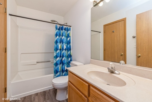 16136 Golf View Drive Lockport, IL 60441 - Photo 10 of 13 a bathroom with a sink toilet and shower