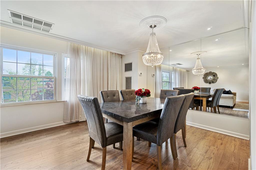 5825 Fifth Avenue, Unit 313 Pittsburgh, PA 15232 - Photo 13 of 24 a view of a dining room and a table chairs and chandelier