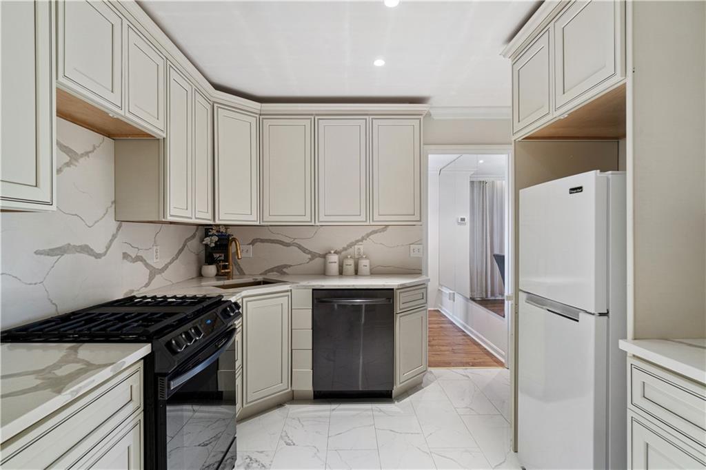 5825 Fifth Avenue, Unit 313 Pittsburgh, PA 15232 - Photo 14 of 24 a kitchen with stainless steel appliances a stove a sink and a refrigerator