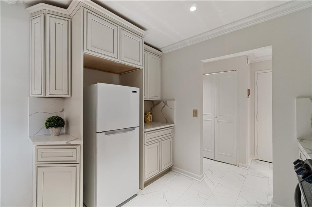 5825 Fifth Avenue, Unit 313 Pittsburgh, PA 15232 - Photo 17 of 24 a kitchen with cabinets and stainless steel appliances