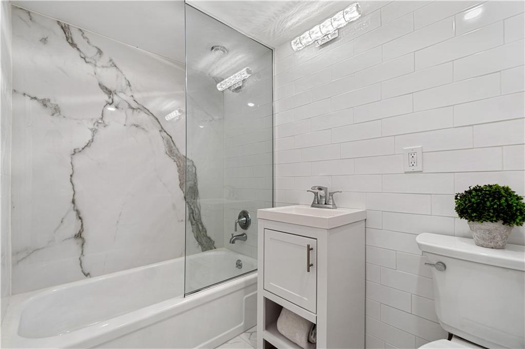 5825 Fifth Avenue, Unit 313 Pittsburgh, PA 15232 - Photo 21 of 24 a bathroom with a sink a toilet and shower