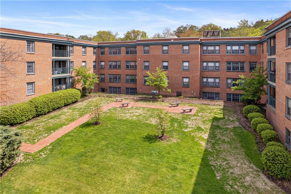 5825 Fifth Avenue, Unit 313 Pittsburgh, PA 15232 - Photo 23 of 24 a view of a building with a yard